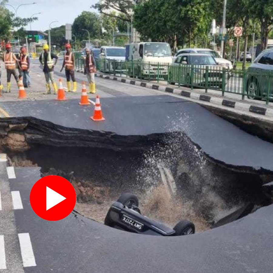 car entirely submerged in the sink hole