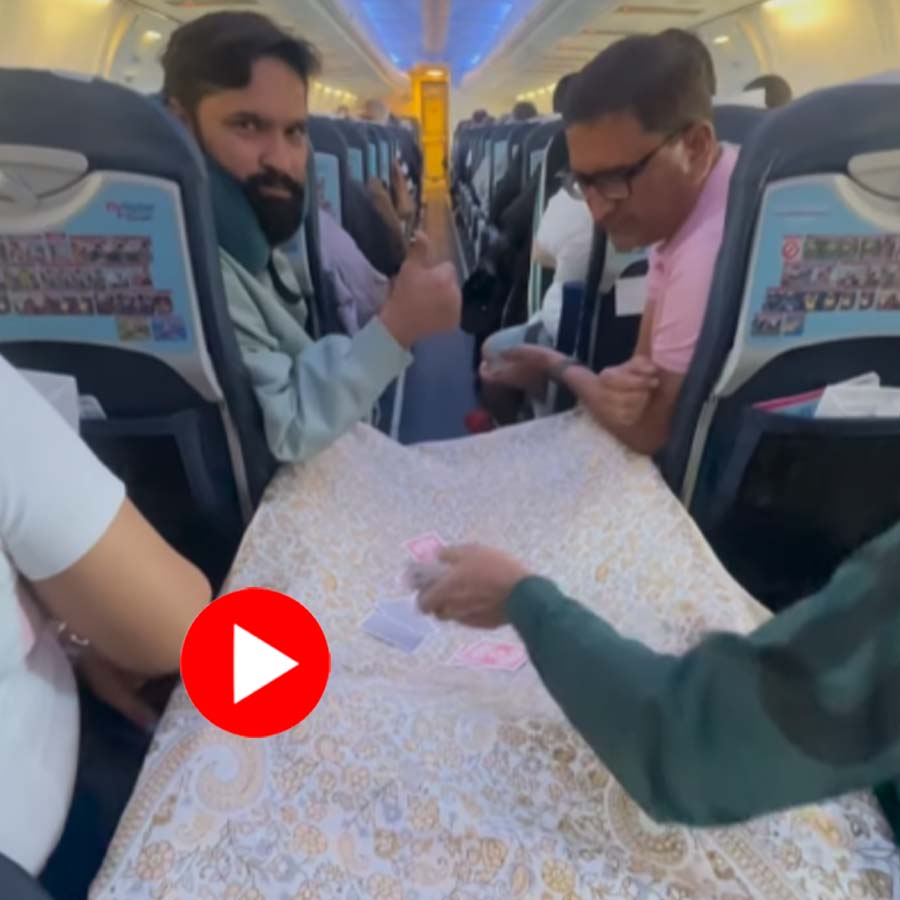 Video shows some people playing card in an airplane