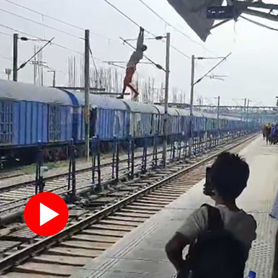 man spotted hanging on a high tension wire