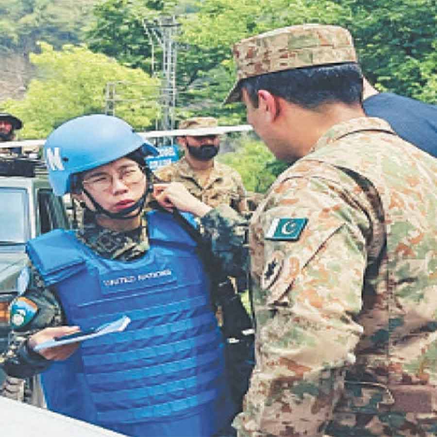 UN observers inspect the site of a damaged areas after Indian strike in Muzaffarabad of PoK dgtl