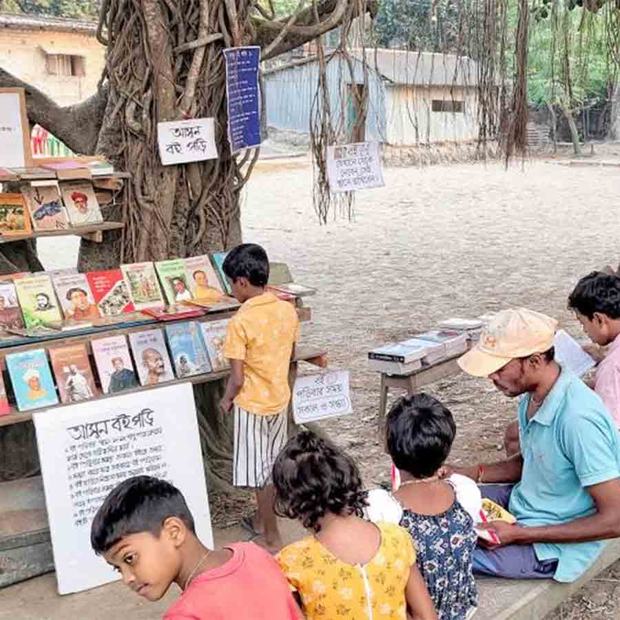 Library under tree shade attracting children in reading books at Basanti
