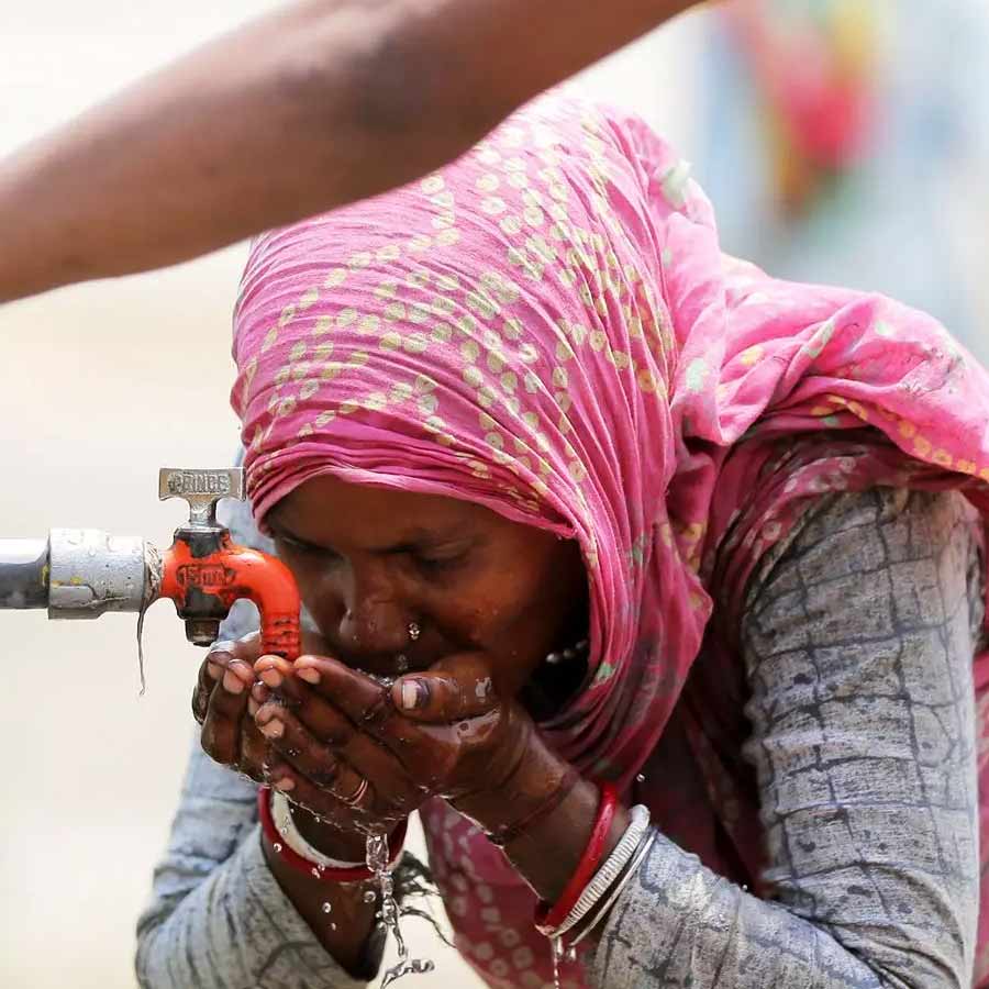 woman drinking water from tap