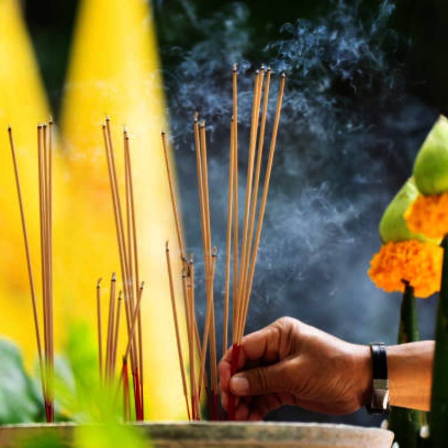 Self-help group members making incense sticks from flowers