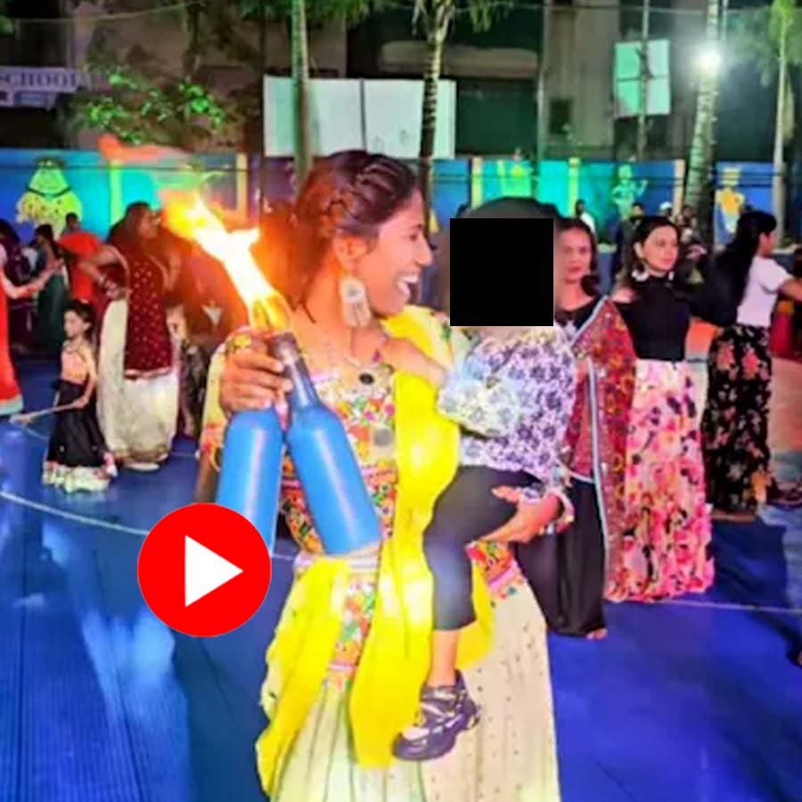 woman juggling bottles while holding a toddler