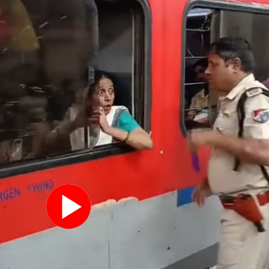 RPF officer approaches and swiftly snatches the device from a woman