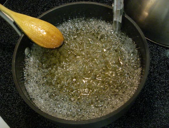 আঁচ কমিয়ে এটাকে নাড়তে থাকুন যত ক্ষণ না চিটচিটে একটা চিনির সিরা তৈরি না হয়। 