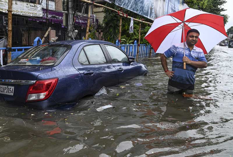জলমগ্ন কলকাতার রাস্তায় আধোডোবা গাড়ি।