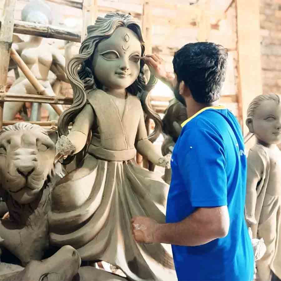 An idol maker from Kalna making puppet liked idols of Goddess Durga