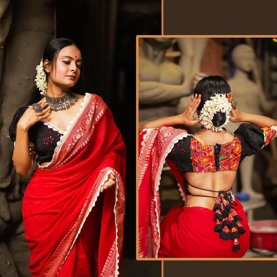 ব্লাউজ় এমন হবে, যা ছিমছাম শাড়ির সৌন্দর্যকে বাড়িয়ে দিতে পারে কয়েক গুণ। সাজগোজ নিয়ে একটু এক্সপেরিমেন্ট করতে পছন্দ করলে এ বারের পুজোয় কোমরখোলা এমন একটি হাকোবা ব্লাউজ় পরেই হয়ে উঠতে পারেন অনন্যা। অফলাইন হোক বা অনলাইন, আগের বারের মতো এ বছরও বাজারে হাকোবা ব্লাউজ়ের চাহিদা তুঙ্গে। ‘মোনরি’র কালো ঘটিহাতা হাকোবা ব্লাউজ়ে রয়েছে সাদা লেসের নকশা। কোমরের অংশে সরু দু’টি দড়িতে ঝুলছে রঙিন লটকন, হাতায় আর পিঠে রঙিন সুতোর জমকালো কারুকাজ। এমন ব্লাউজ়ের সঙ্গে লাল টুকটুকে একটা শাড়ি, অক্সিডাইজ়ড গয়না, ছোট একটা টিপ আর খোঁপায় ফুলেল সাজ— পুজোয় প্রিয়জনের নজর কাড়তে আর কী চাই?