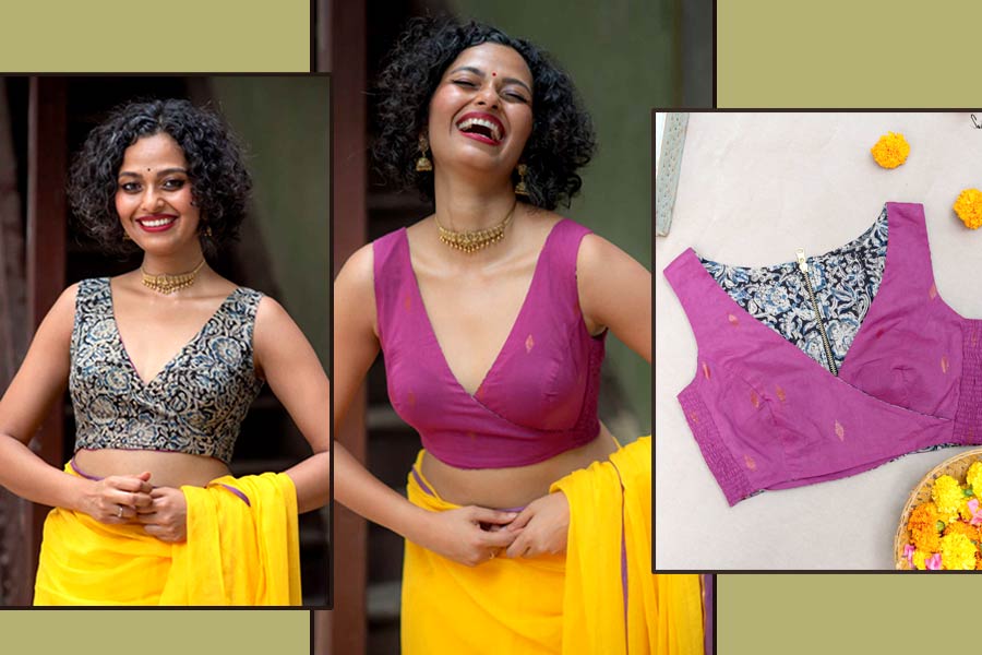 এই ব্লাউজ় উল্টো পরে নিলেও ক্ষতি নেই। হাতকাটা ডিপ ভি নেকলাইনের ‘সুতা’র ‘আলাট পালাট জামুন’ ব্লাউজ়টি পুজো উপলক্ষে আপনার শপিং লিস্টে রাখতেই পারেন। ভাবুন তো, একটাই ব্লাউজ়ে কখনও কালো কলমকারি প্রিন্ট, আবার পাল্টে দিলেই জাম রঙের সুতির কাপড়ে জামদানির নকশা। ব্যাপারটা ঠিক এক ঢিলে দুই পাখি মারার মতো। পুজোর ষষ্ঠীর দিন ইচ্ছে হলে কলমকারি প্রিন্টের সঙ্গে একরঙা একটি শাড়ি পরে নিলেন, আবার নবমীর দিন জাম রঙের ব্লাউজ়ের সঙ্গে হলুদ শাড়ি দিয়ে জুটি বাঁধলেন। দুই দিন যে একই ব্লাউজ় পরেছেন, তা আপনি ছাড়া আর কেউই টের পাবে না। একে ‘বহুরূপী’ ব্লাউজ় বললেও মন্দ হয় না!