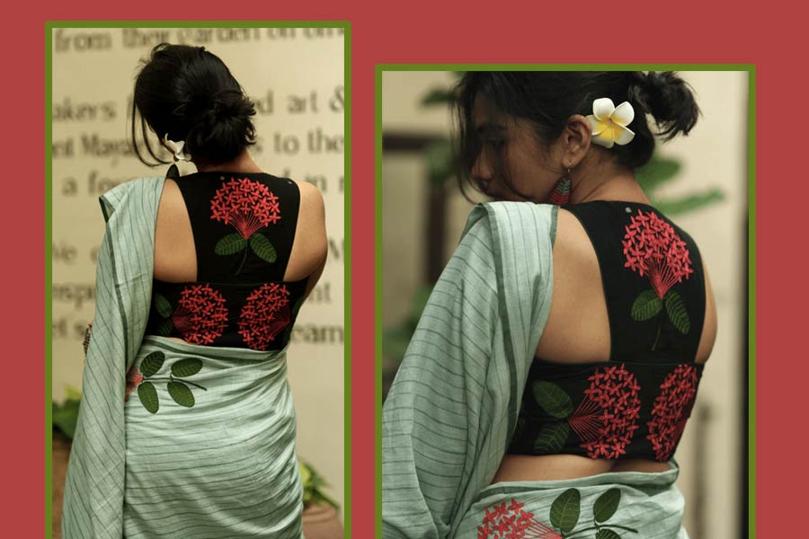 কালো জামদানির উপর রঙ্গন ফুলের নকশা, দুর্গাপুজোর ষষ্ঠী কিংবা সপ্তমীর রাতের সাজের সঙ্গে এমন একটি ব্লাউজ় কিন্তু দারুণ মানাবে। যাঁরা হাতকাটা ব্লাউজ় পরতে ভালবাসেন ‘পরমা’র ‘ব্ল্যাক রঙ্গন’-এর ডিজ়াইন তাঁদের মনে ধরবে। হ্যাল্ডলুম সিল্ক হোক বা কটন— এ রকম একটা ব্লাউজ়ের সঙ্গে মেলবন্ধন বেশ চোখে পড়ার মতো। ব্লাউজ়ের পিঠ জুড়ে  ফুলেল নকশা— এ বার পুজোর বাজারে হিট। তবে হ্যাঁ, এমন ব্লাউজ়ের সঙ্গে খোঁপা কিন্তু মাস্ট! পিঠভর্তি নকশা লুকিয়ে রাখার কি কোনও মানে আছে?