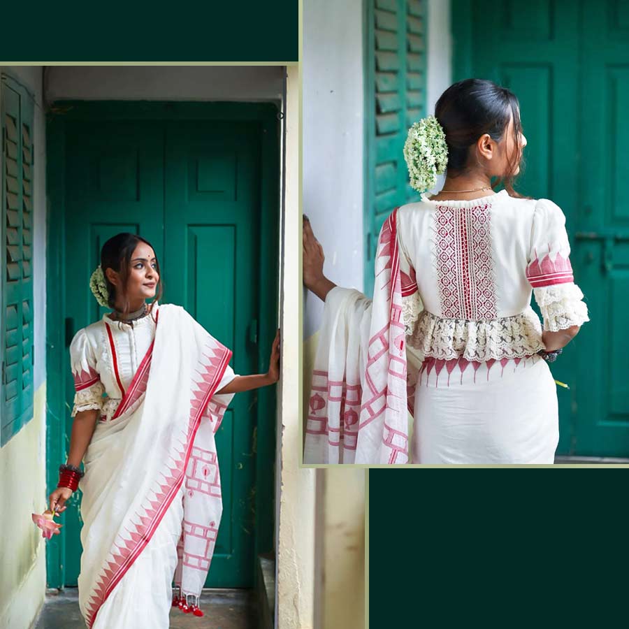 দুর্গাপুজো মানেই একটা সাদা-লাল শাড়ি মাস্ট! অষ্টমী কিংবা দশমীর সাজ সম্পূর্ণ করতে সাদা-লাল শাড়ির সঙ্গে মানানসই সাবেকি ব্লাউজ় না হলেই নয়। পুরনো দিনের ফ্যাশন বার বার ফিরে আসে হালের ফ্যাশনে। লেসের কারুকাজ একটা সময়ে সেকেলে হলেও আবার ফিরে এসেছে সেই ট্রেন্ড। ‘মোনরি’র পুজো কালেকশনের হাতে বোনা জামদানি কটনের সাদা ব্লাউজ়টি অষ্টমীর সকালের সাজের জন্য হতে পারে একদম ফিট। দেখতে খানিকটা ক্রপটপের মতো। হাতায় ও ব্লাউজ়ের ধার বরাবর সাদা লেসের সূক্ষ্ম কারুকাজ ব্লাউজ়ের নকশায় সাবেকিয়ানার ‘টাচ্’ যোগ করেছে। সাবেকি সাজে পুজোর ভিড়ে নজর কাড়তে চাইলে এমন একটি ব্লাউজ় রাখতেই পারেন পছন্দের তালিকায়। 