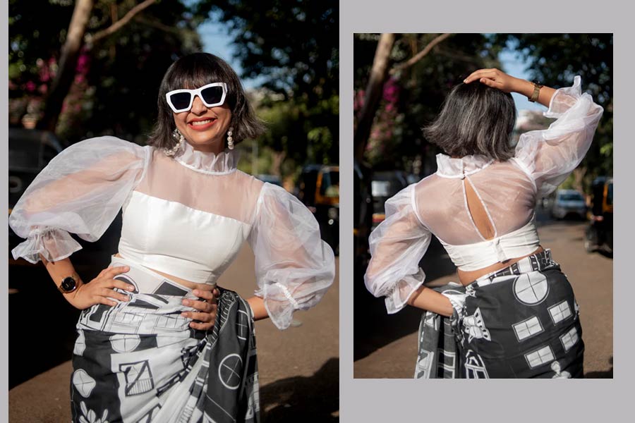 পুজোতে একটু ‘কোয়ার্কি’ সাজে সকলের নজর কাড়তে চান? সে ক্ষেত্রে ব্লাউজ় নিয়ে কিন্তু একটু পরীক্ষা-নিরীক্ষা করতেই পারেন। শিফন কিংবা জর্জেটের একটা ফিনফিনে শাড়ির সঙ্গে পরনে থাকতে পারে সাদা অরগ্যানজ়ার পাফ হাতা ব্লাউজ়। ‘সুতা’র ‘লেডি মায়রা’ ব্লাউজ়টির নকশা খানিক ক্রপ টপের মতোই বটে। ইচ্ছে করলে ক্রপ টপ দিয়েও সুন্দর করে শাড়ি স্টাইল করে বেরিয়ে যেতে পারেন প্যান্ডেল হপিংয়ে। খুব বেশি সাজের প্রয়োজন নেই, শাড়ির সঙ্গে একটা ক্রপটপ, রোদচশমা, কানে দুল আর হাতঘড়ি— ব্যাস, পুজোয় ঘোরাঘুরির জন্য একেবারে তৈরি।