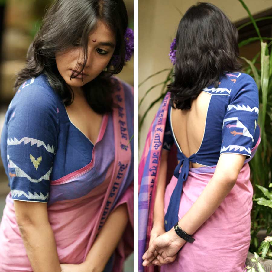 বয়স যা-ই হোক না কেন, এ বার পুজোয় জামদানি ব্লাউজ় বেশ মনে ধরছে মহিলাদের। আর যদি সেই ব্লাউজ় হয় ইন্ডিগো রঙের, তা হলে তো কথাই নেই। ‘পরমা’র পুজো সম্ভারে ইন্ডিগো জামদানি পিঠকাটা ব্লাউজ়ের নকশা কিন্তু বেশ ভিন্ন। পিঠের শেষপ্রান্তে দড়ির বাঁধন সাবেকিয়ানার সঙ্গে আধুনিকতার একটা মিশেল তৈরি করেছে। সুতির একটা শাড়ির সঙ্গে এমন একটা ব্লাউজ় পরলে খুব বেশি সাজগোজের প্রয়োজন নেই। মণ্ডপে নজর কাড়তে ব্লাউজ়ের পিঠের দিকের এই বাঁধনই যথেষ্ট।