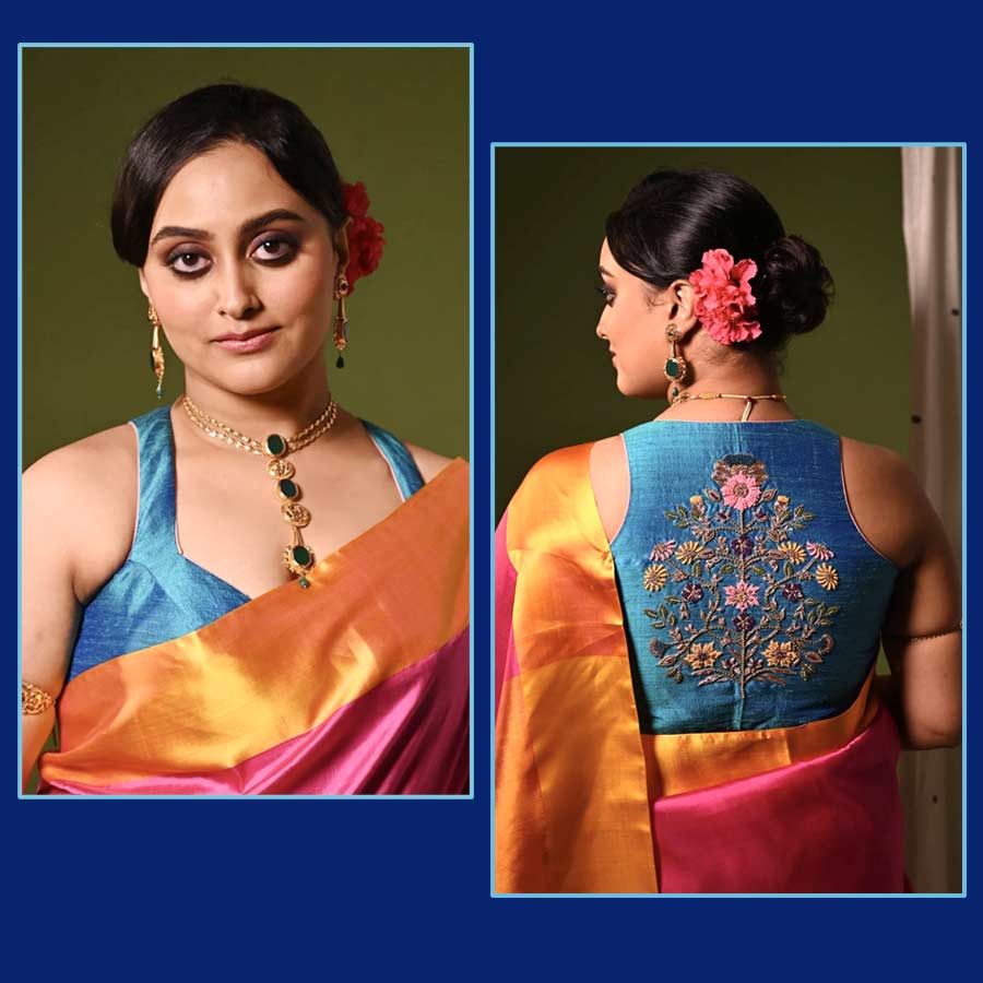 মুঘল যুগে তৈরি দুর্গের নকশা যদি ব্লাউজ়ের পিঠে ফুটে ওঠে, তা হলে কেমন হয়? সেই ভাবনা থেকেই পোশাকশিল্পী পরমা ঘোষ বানিয়ে ফেলেছেন ‘ফিরোজ়ি মোগলাই টাইল ট্রি’ ব্লাউজ়ের নকশা। ‘পরমা’র বোটনেক ব্লাউজ়ের পিঠে যে ফুলেল কারুকাজ, তা মুঘল আমলের দুর্গের গায়ের আঁকা নকশা থেকে অনুপ্রাণিত। খুব বেশি জমকালো নয়, হাতে বোনা এই ব্লাউজ়ের নকশা আর পাঁচটা ডিজ়াইনার ব্লাউজের থেকে বেশ আলাদা। এ বছর বাজারে বোটনেক ব্লাউজ়ের পিঠভর্তি কারুকাজ বেশ ট্রেন্ডিং। হাতকাটা ব্লাউজ়ে ভরাট এম্ব্রয়ডরি কারুকাজ চাইলে এমন ব্লাউজ় একটি কিন্তু শপিং কার্টে যোগ করতেই পারেন।    