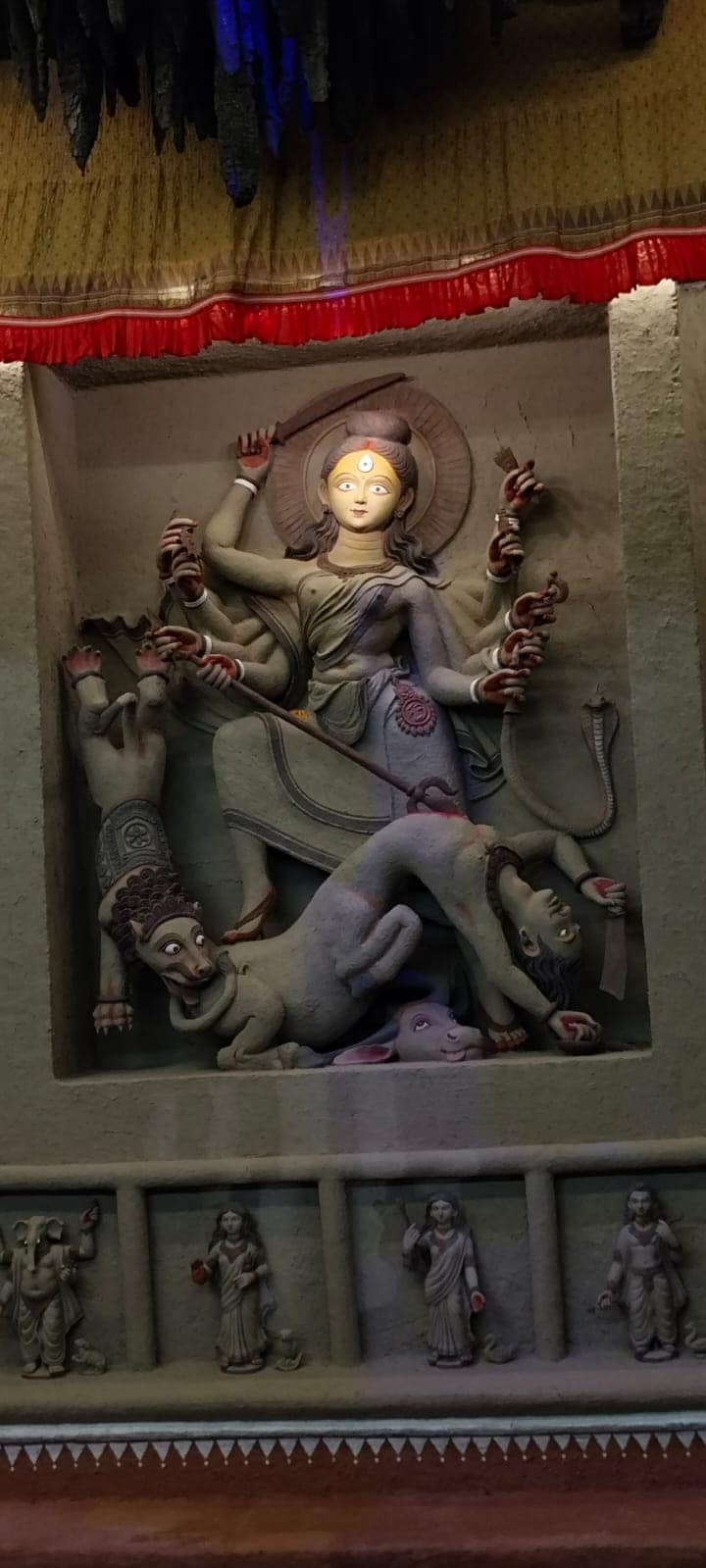 আর তার পাশেই একটি আটচালায় বিরাজ করছেন দেবী তার চার সন্তান নিয়ে। 