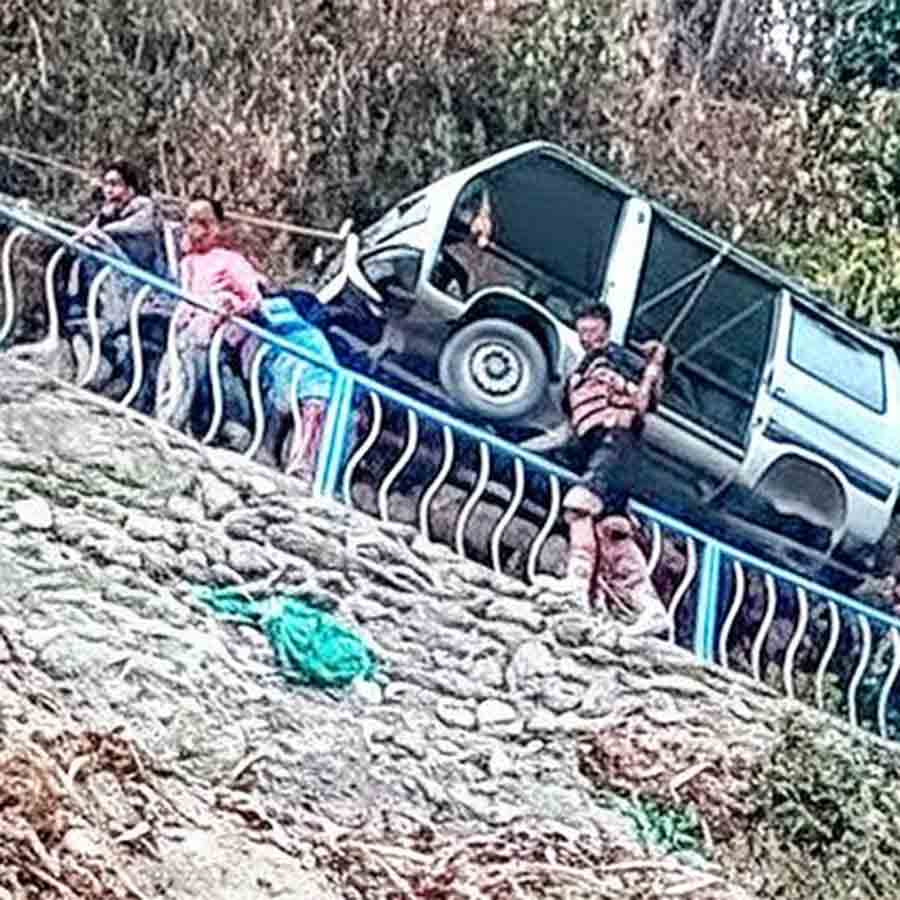 কাঁধে করে গ্রামে গাড়ি নিয়ে যাচ্ছেন চুনাভাটির বাসিন্দারা।