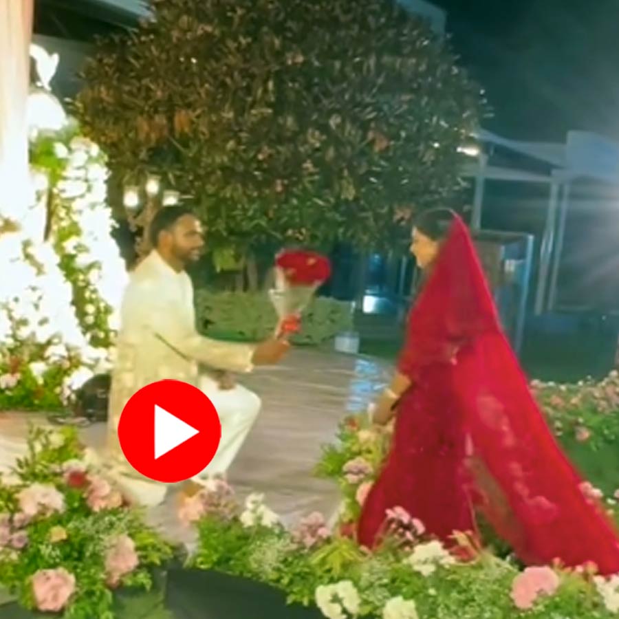 Video Shows priest come in between bride and groom while photoshoot