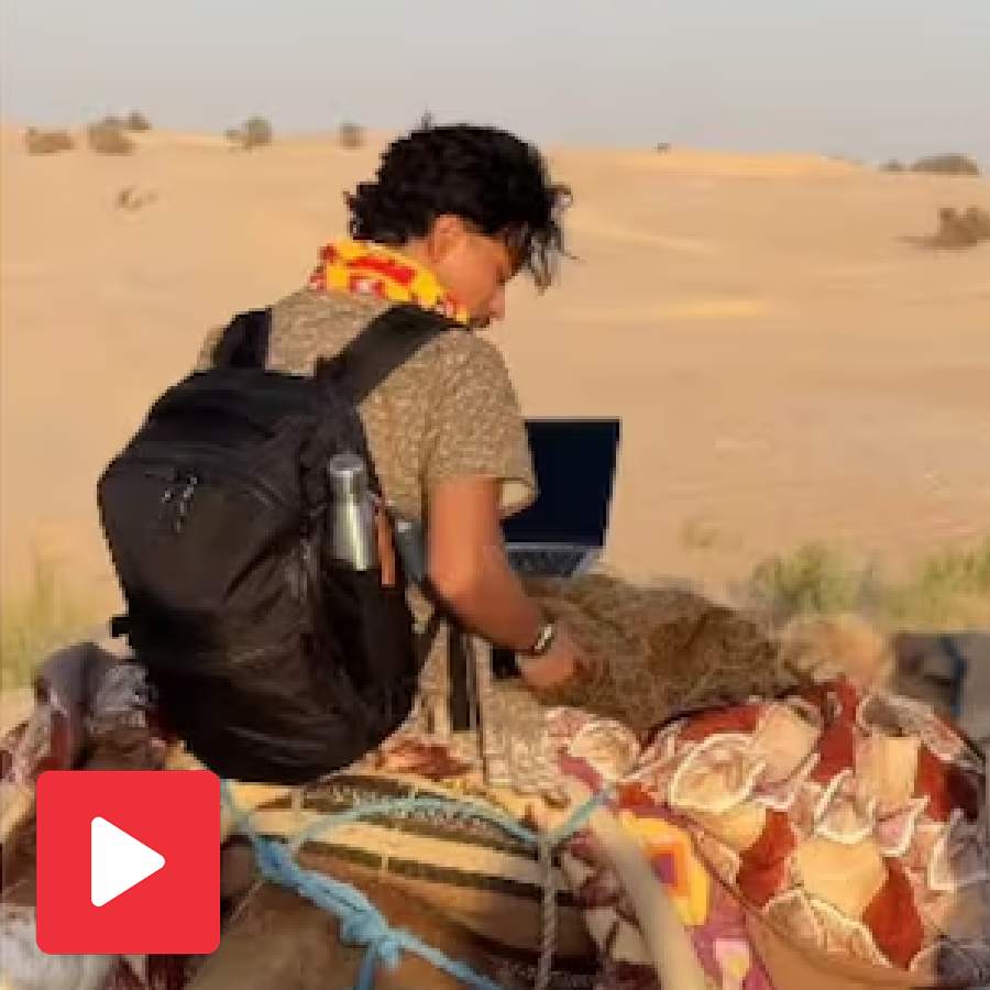 Video shows Young man working on laptop while riding camel in Sahara