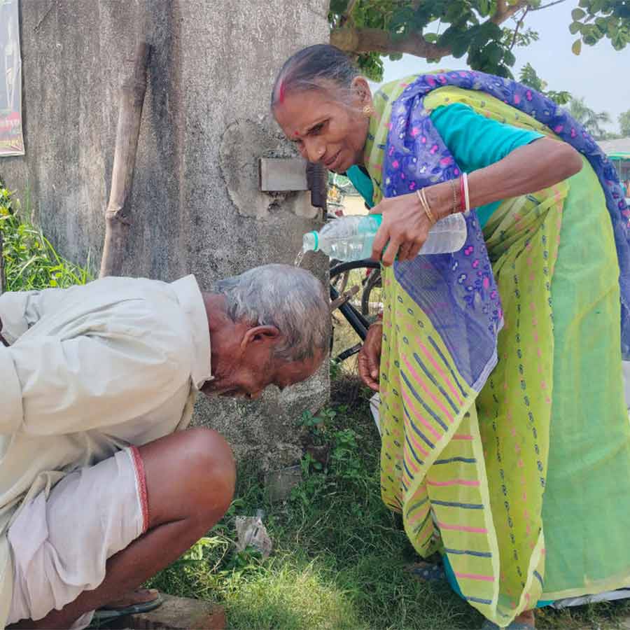 জনকল্যাণ শিবিরে এসে রোদে অসুস্থ বোধ করছিলেন বৃদ্ধ। মাথায় জল দিচ্ছেন স্ত্রী। নন্দকুমারে।