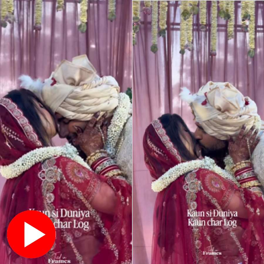Video shows bride and groom kiss each other on wedding stage