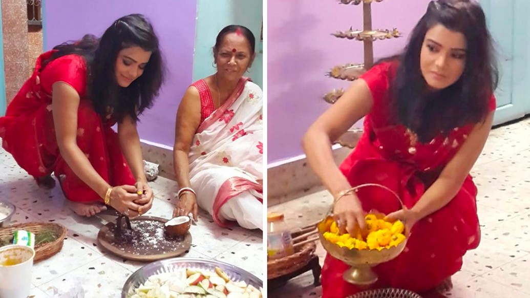 কখনও নারকেল কোরাচ্ছেন, কখনও বা জোগাড় করছেন পুজোর উপচার- সবটাই একা হাতে। লাল শাড়িতে ঘরের লক্ষীটি যেন। প্রতি বছরের মতো এ বারও চেনা ছবি টেলিপর্দার পরিচিত মুখ সোনালী চৌধুরীর বাড়িতে।