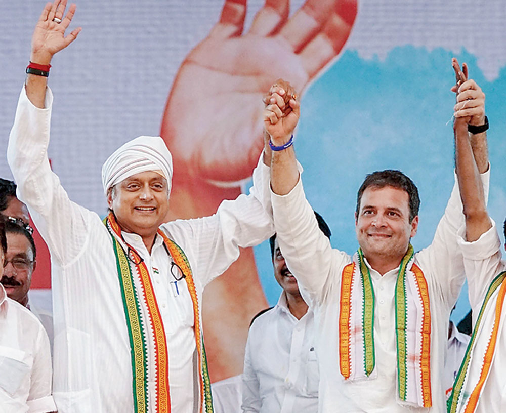 Rahul Gandhi and Shashi Tharoor, with headgear covering his bandage, at an election rally in Thiruvananthapuram on Tuesday. 
