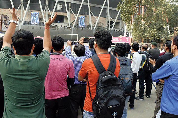 Fans cheer outside the Eden Gardens when Virat Kohli scored a century on Saturday afternoon. 