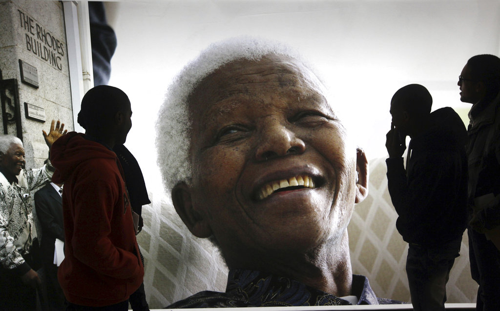 This June 27, 2013, file photo shows visitors at the Nelson Mandela Legacy Exhibition in Cape Town, South Africa. 