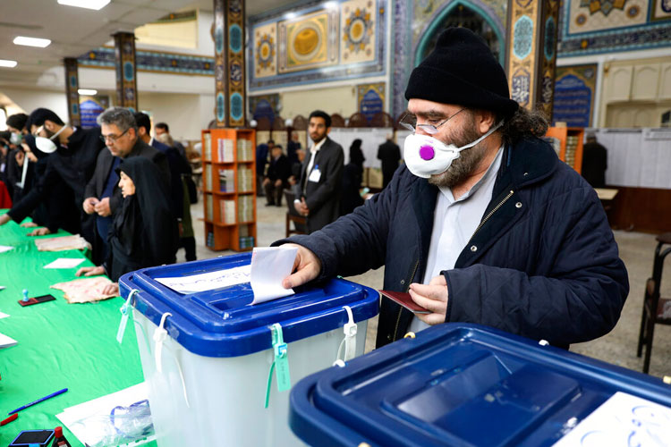 A voter casts his ballot in the parliamentary elections in a polling station in Tehran on Friday