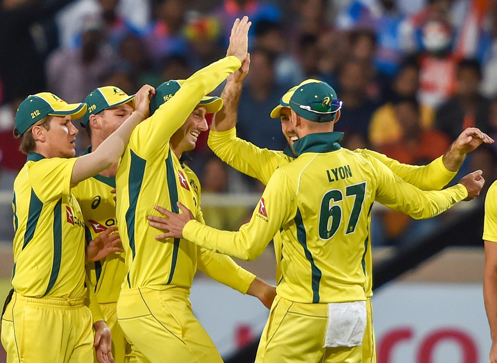 Australian cricketers celebrate the dismissal of India's S. Dhawan during the 3rd ODI cricket match in Ranchi on Friday, March 8, 2019. 