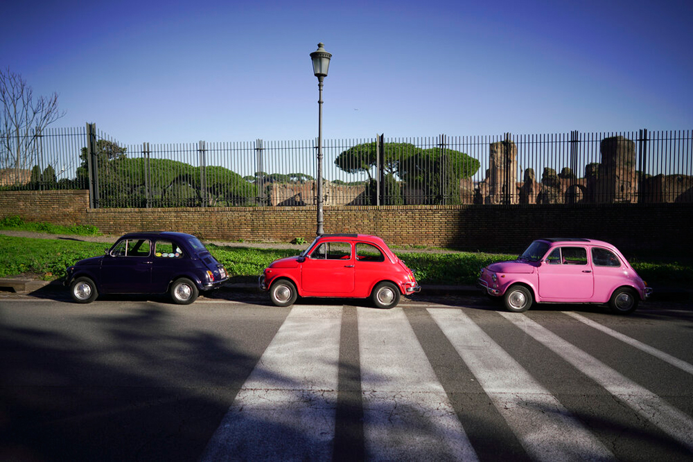Three vintage FIAT 500 cars in Rome on December 26. The FIAT 500, once one of Italy's most inexpensive and small car, has now become a collectors vehicle