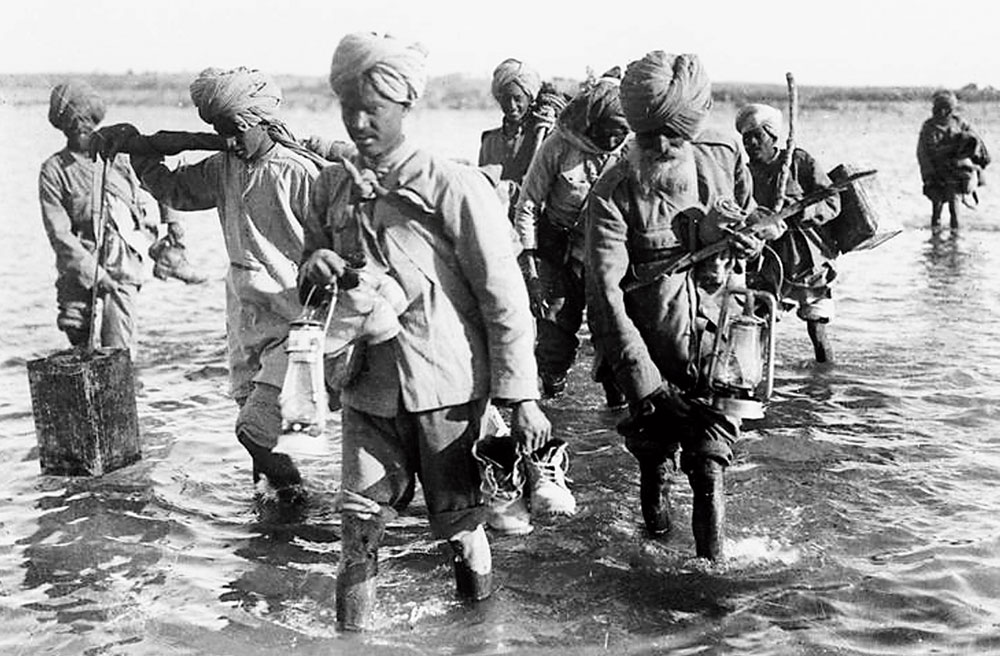 Indian orderlies crossing a river in Mesopotamia during WWI. 