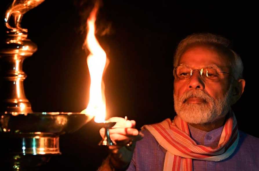 This image posted on Indian Prime Minister Narendra Modi's twitter account shows Modi lighting an oil lamp to mark the country's fight against the Covid-19 pandemic in New Delhi, India, Sunday, April 5, 2020.