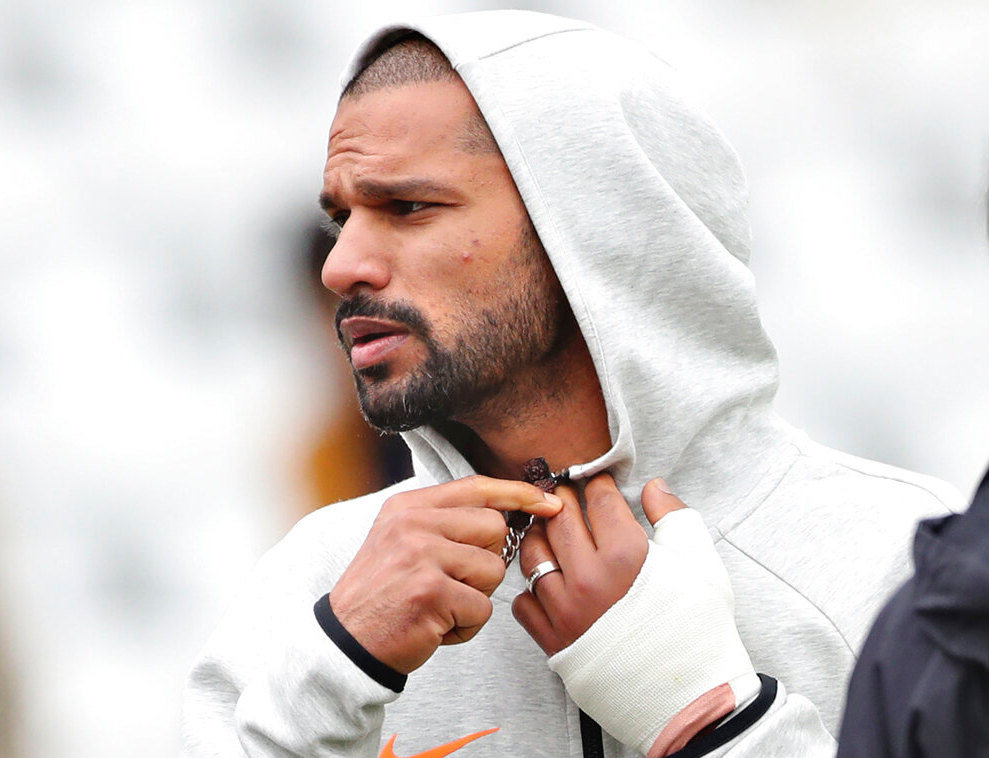 Shikhar Dhawan is seen with his left hand covered with a cast during team's training session ahead of their match against New Zealand at Trent Bridge in Nottingham, England, Wednesday, June 12, 2019.