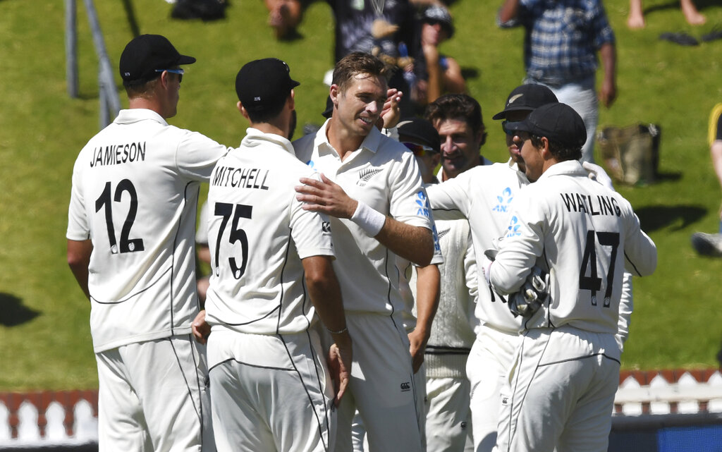 New Zealand's Tim Southee, is congratulated by teamates after taking the final wicket of India's Jasprit Bumrah