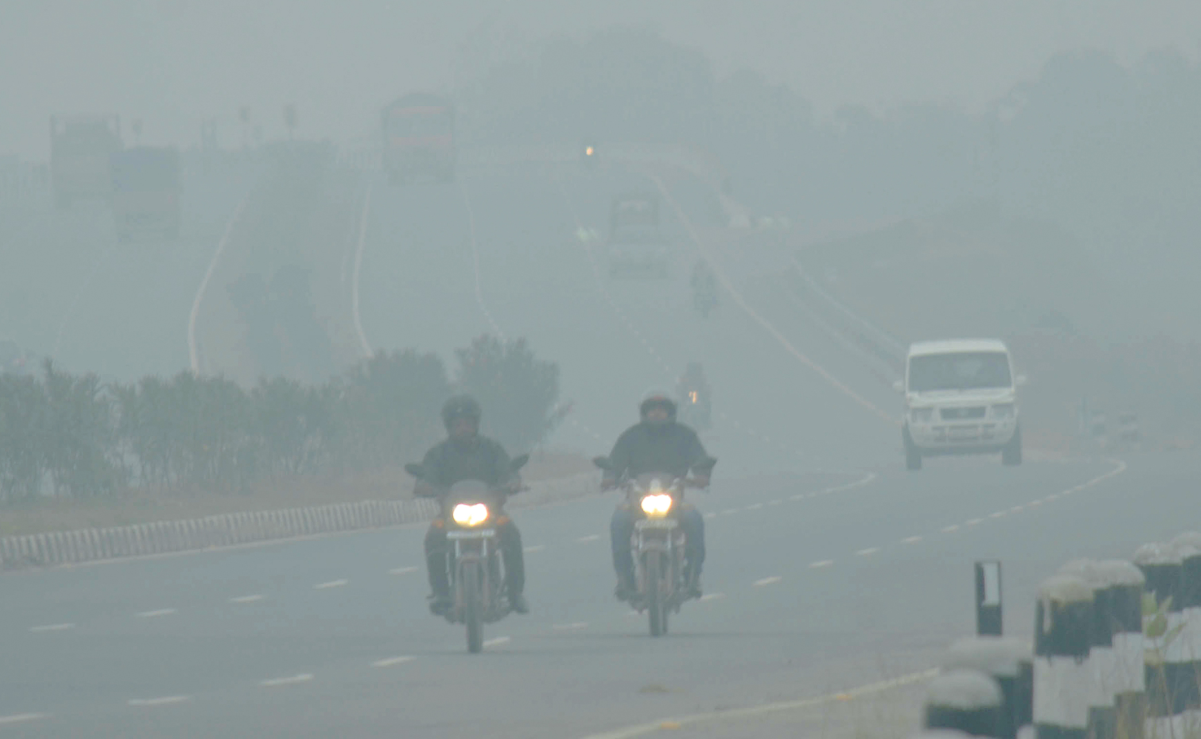 Vehicles negotiate a foggy stretch of Ring Road in Kanke.