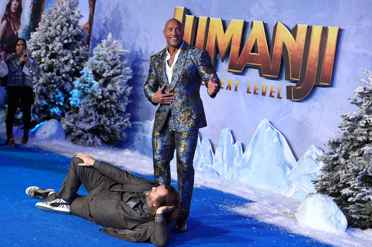 Jack Black, lying down, and Dwayne Johnson pose at the Los Angeles premiere of ‘Jumanji: The Next Level’ on December 9