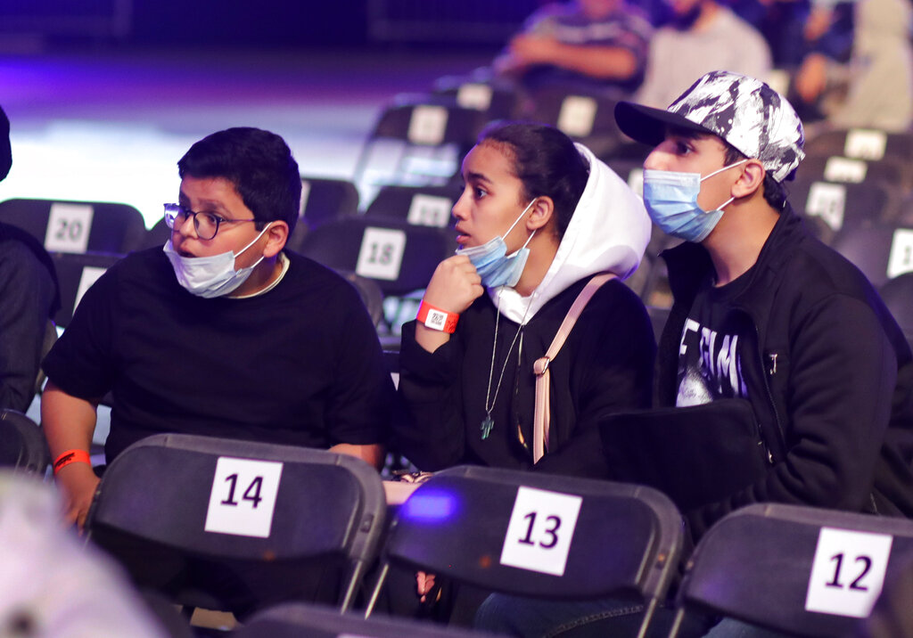 Saudi wrestling fans wear protective masks as they wait for wrestling matches of WWE Super ShowDown in Riyadh
