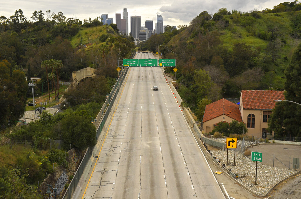 Extremely light traffic moves along the 110 Harbor Freeway toward downtown mid afternoon, Friday, March 20, 2020, in Los Angeles. Traffic would normally be bumper-to-bumper during this time of day on a Friday. California Gov. Gavin Newsom is ordering the state's 40 million residents to stay at home indefinitely. His order restricts non-essential movements to control the spread of the coronavirus that threatens to overwhelm the state's medical system. He called up 500 National Guard troops Thursday to help with distributing food.