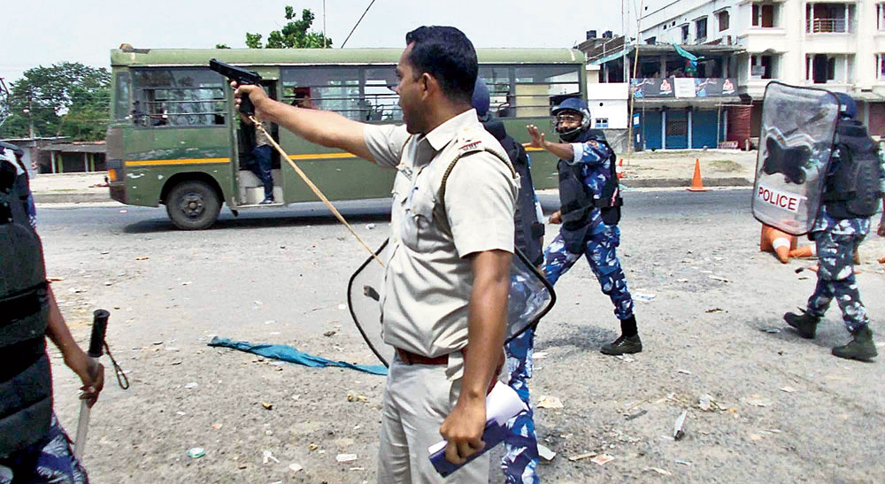 A police officer during the violence in Chopra on Thursday