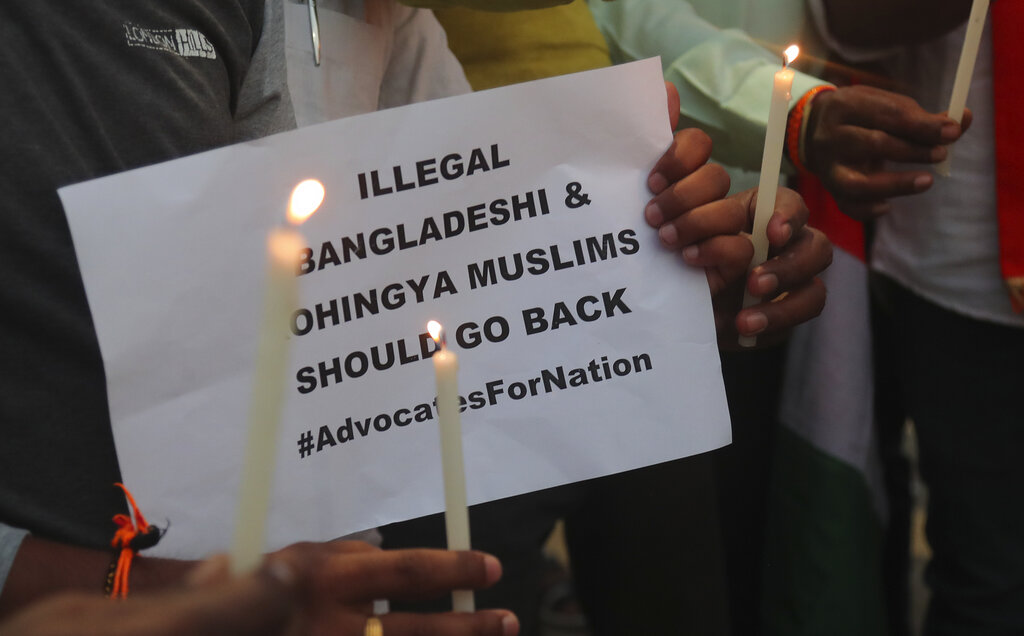 Activists of Hindu Sangathan participate in a candle light protest to paying tribute Indian security officers who were killed during communal violence in New Delhi, in Hyderabad, on Saturday