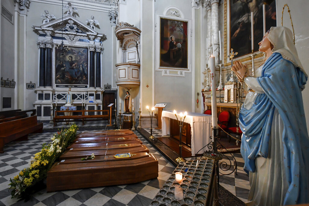 Coffins wait to be transported to cemetery, in the church of Serina, near Bergamo, Northern Italy, Saturday, March 21, 2020. Italy’s tally of coronavirus cases and deaths keeps rising, with new day-to-day highs: 793 dead and 6,557 new cases.