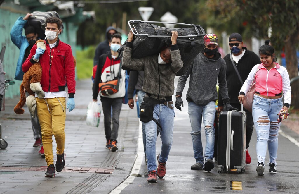 Venezuelan migrants leave on foot toward the Venezuelan border, with the aim of leaving Colombia after a lockdown ordered by the government in an effort to prevent the spread of the new coronavirus, in Bogota, Colombia, Monday, April 6, 2020.