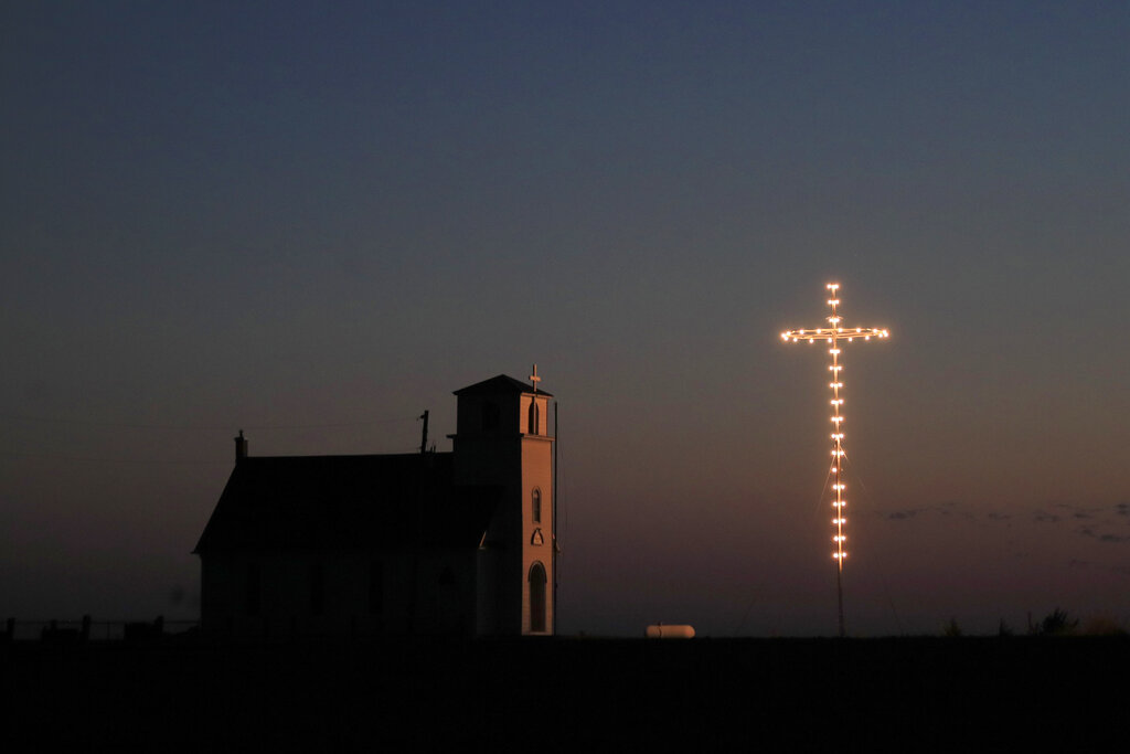 Known as The Lighted Cross Church, Excelsior Lutheran Church near Wilson, Kan., is dark, on Friday, April 10, 2020. The church is not holding their normal Good Friday service during the coronavirus outbreak.