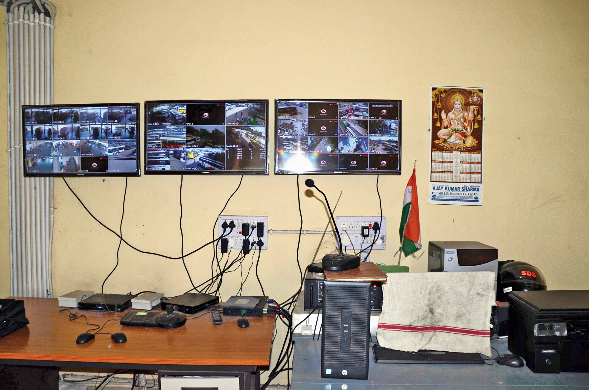 The screens monitoring the CCTV cameras in the building show an alarming number of black rectangles signifying defunct devices.
