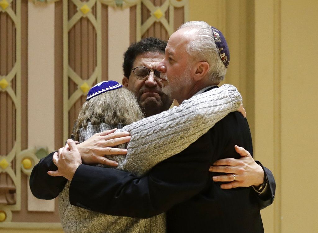 Rabbi Jeffrey Myers (right) of Tree of Life Congregation hugs Rabbi Cheryl Klein (left) of Dor Hadash Congregation and Rabbi Jonathan Perlman during a community gathering held in the aftermath of the deadly shooting,