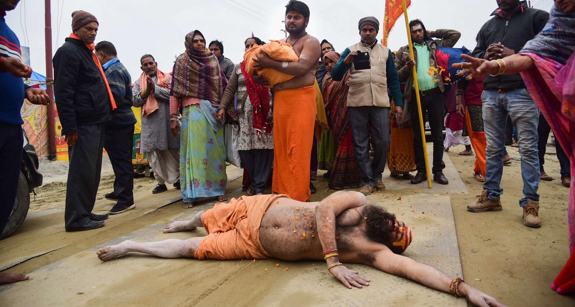 A sadhu rolls on the road as an appeal to build the Ram temple in Ayodhya, during the Kumbh Mela in Allahabad on Sunday, January 27.