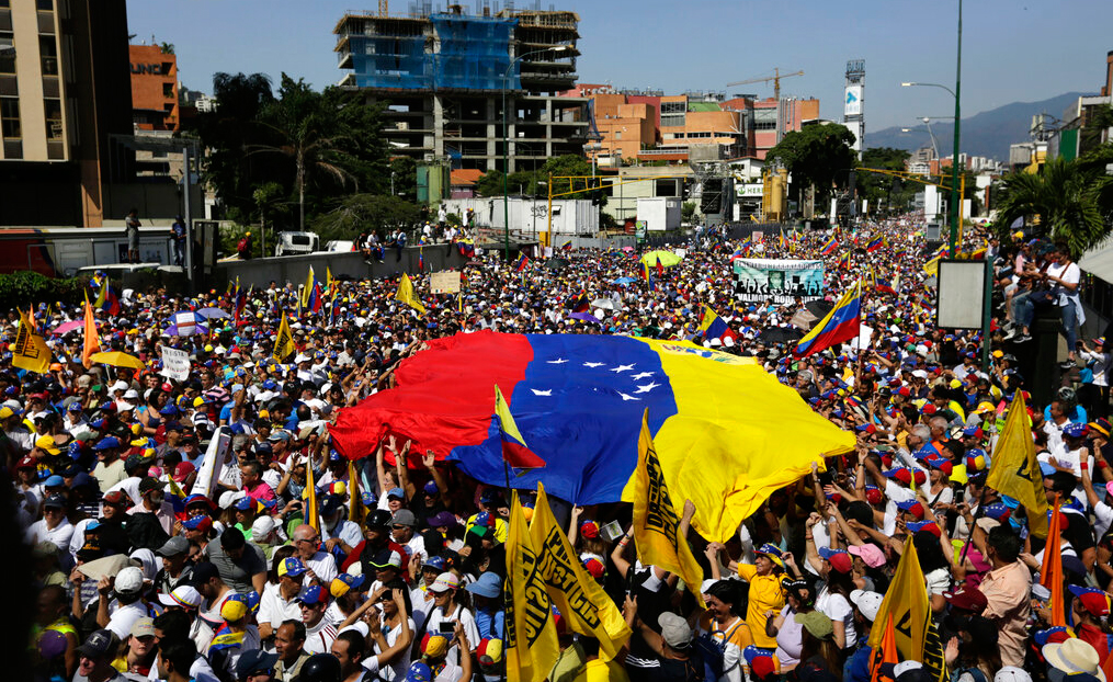 Anti-government protesters gather for the start of a nationwide demonstration demanding the resignation of President Nicolas Maduro, in Caracas, Venezuela, Saturday, Feb. 2, 2019. 