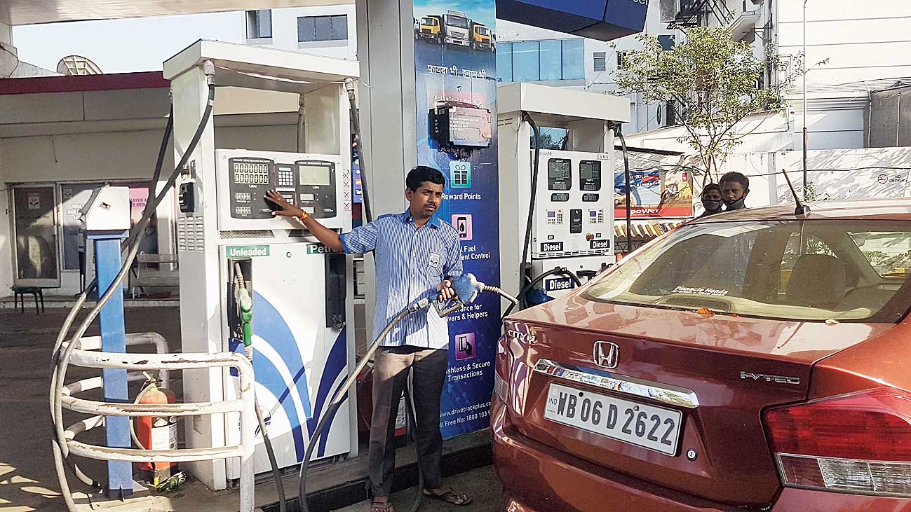 Raghunath Das fills petrol in a car at the CK Block petrol pump next to Tank 9